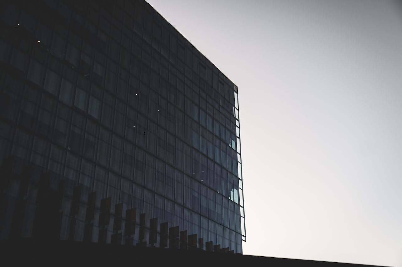 Modern building with contemporary glass facade of business complex under cloudless sky in daytime